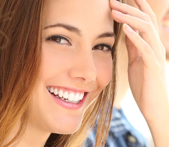 Woman sitting between people looking over her right shoulder